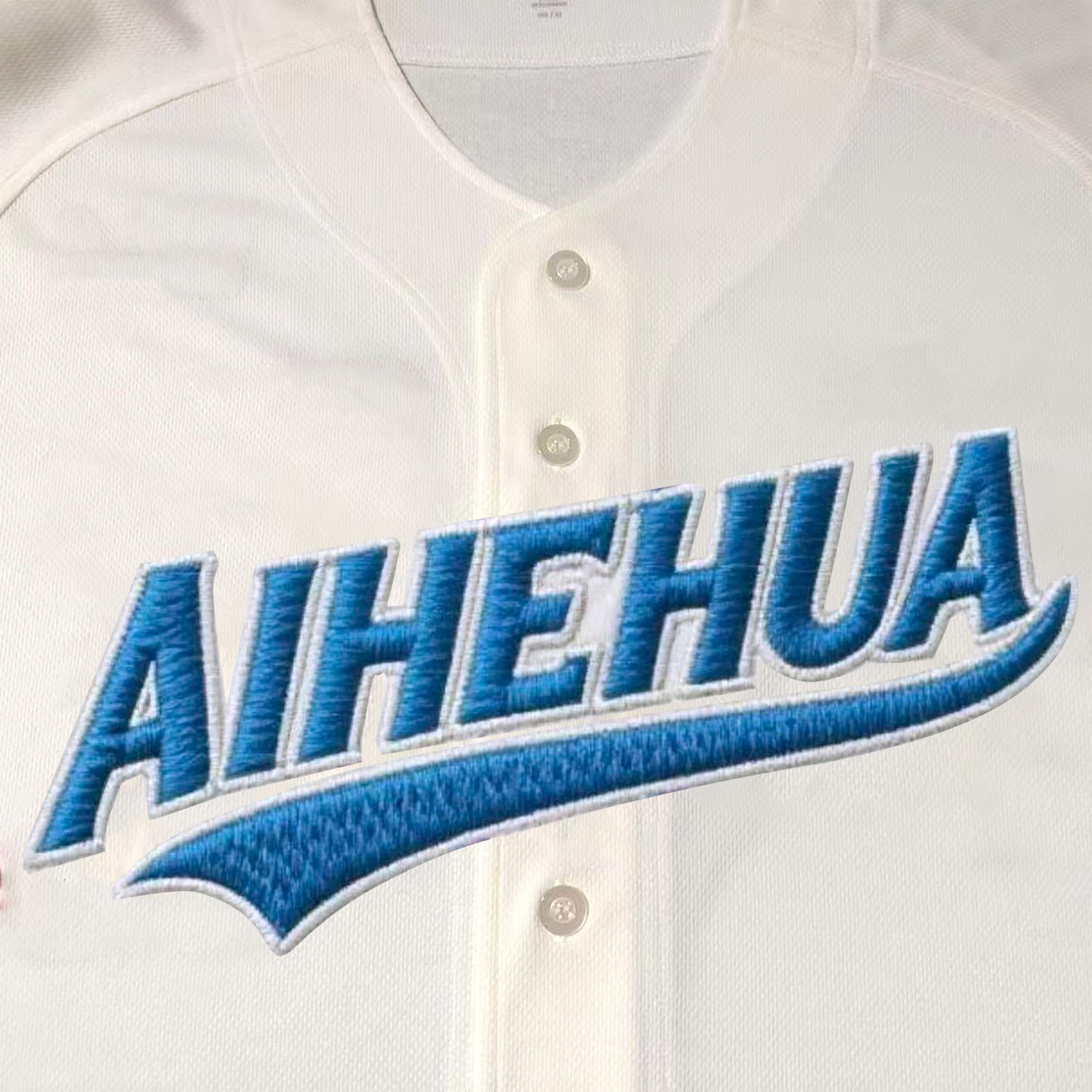 Close view of blue embroidered lettering and stitching on a custom baseball jersey