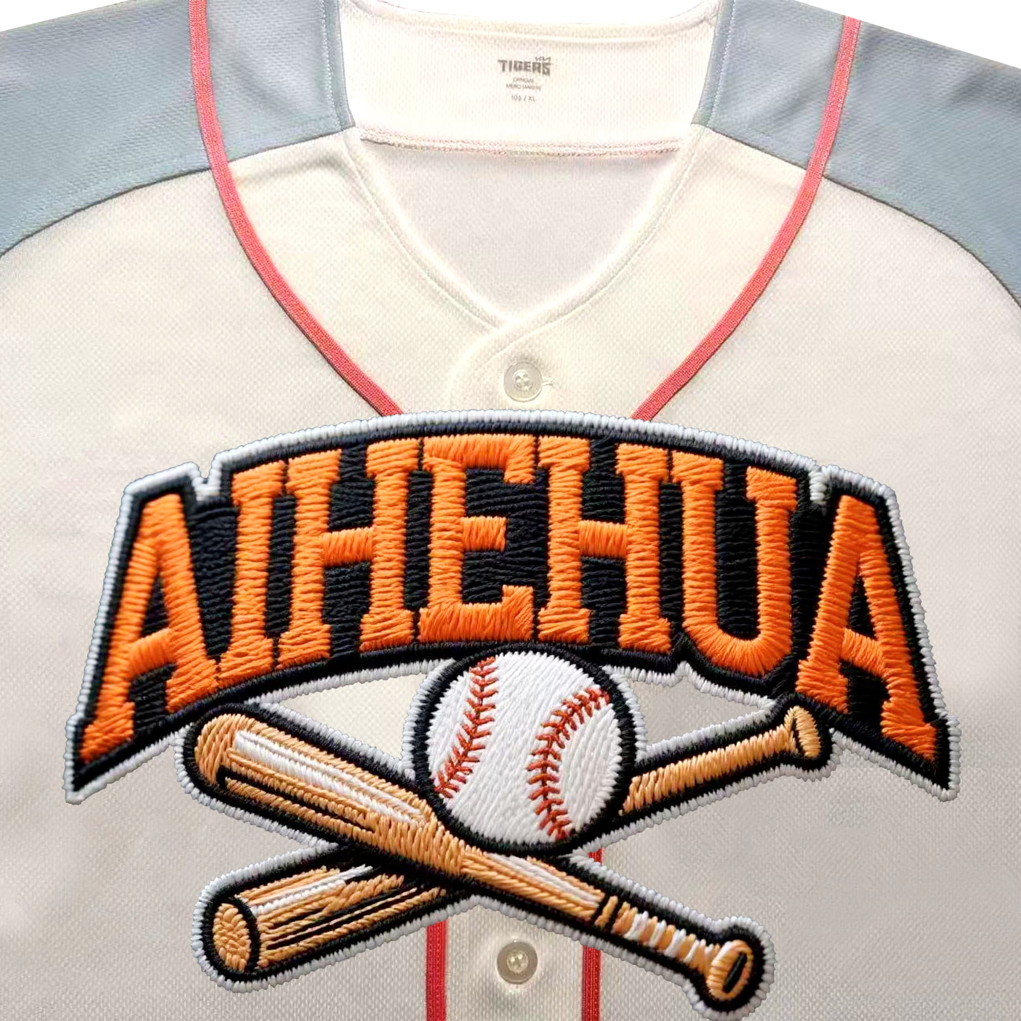 Close view of orange appliqué and embroidered lettering on a custom baseball jersey