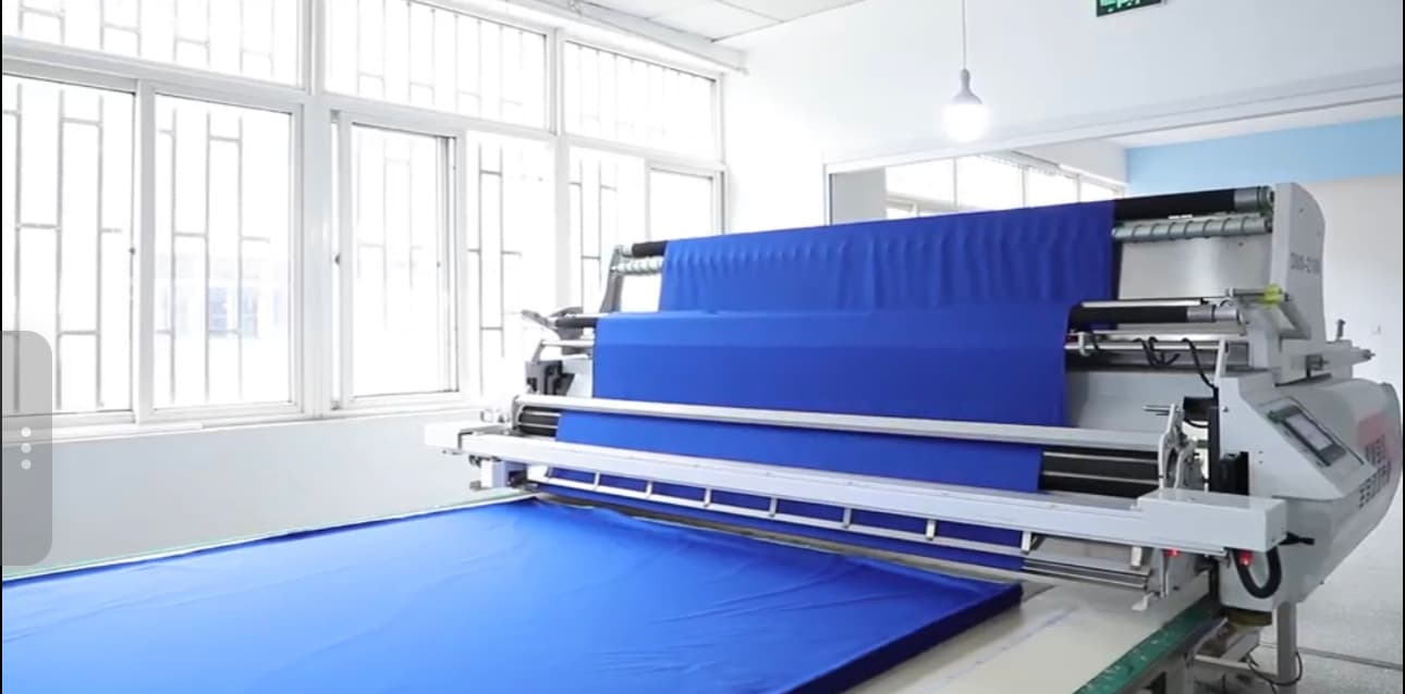 Fabric cutting equipment preparing panels for custom baseball jerseys