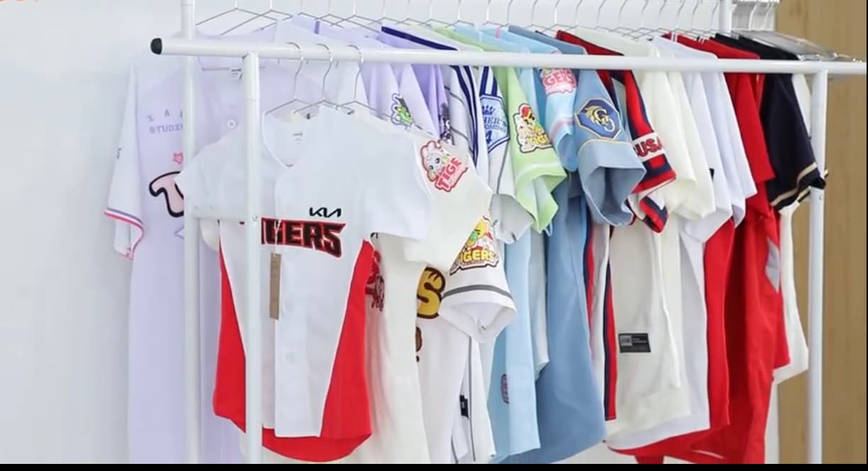 Finished custom baseball jerseys arranged on a garment rack