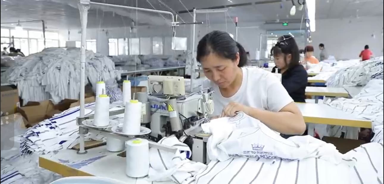 Close view of a baseball jersey being assembled on the production line