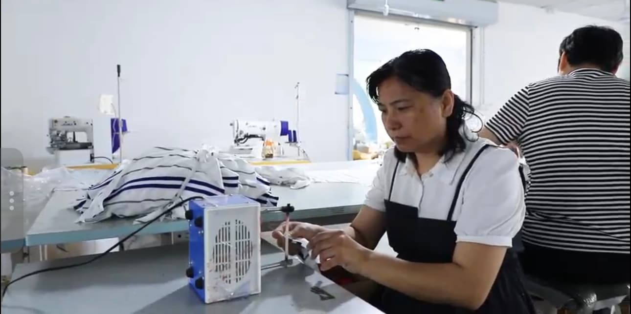 Team member completing trim and finishing work on a garment
